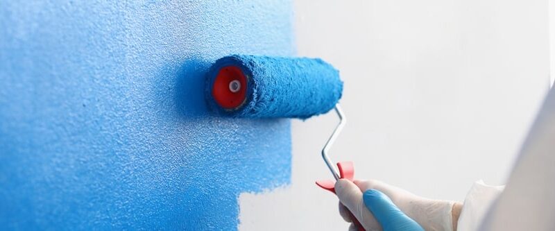 Professional painter applying a fresh coat of paint to a residential interior wall in a modern Byford home, showcasing expert residential painting services in WA.